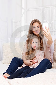 Pretty woman and child taking a selfie