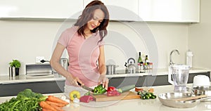 Pretty woman chopping vegetables