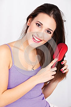 Pretty woman combing her hair