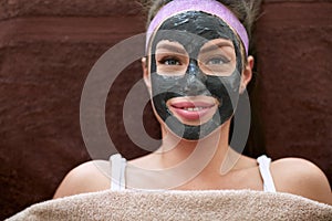 Pretty woman with cosmetic black mask on face