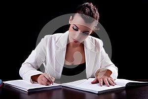 Pretty woman in desk with papers, writing
