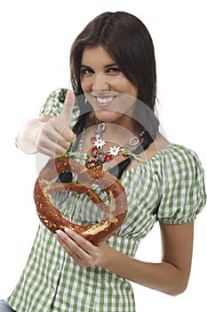 Pretty woman with dirndl and pretzel