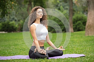 Pretty woman doing yoga meditation in the lotus