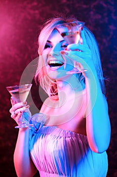 Pretty woman drinking cocktail in nightclub