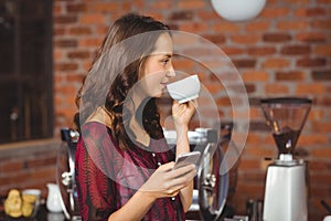 A pretty woman drinking a coffee