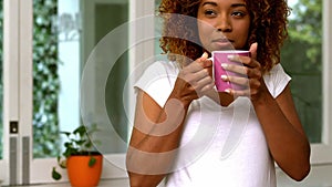 Pretty woman drinking coffee in the kitchen