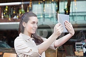 Pretty woman drinking coffee in the street