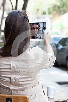 Pretty woman drinking coffee in the street