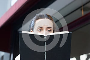 Pretty woman drinking coffee in the street