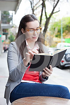 Pretty woman drinking coffee in the street