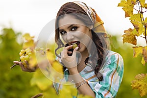 Pretty woman eating grapes in vineyard, pretty woman in vinery