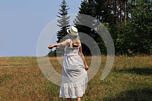 Pretty woman enjoying in fresh air on summer day in nature