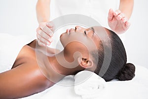 Pretty woman enjoying a reiki technique