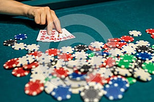 pretty woman in evening black dress plays poker in the casino