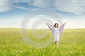 Pretty woman with fabric running on meadow