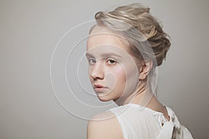 Pretty woman face with blonde hair on white background