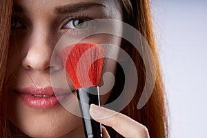 pretty woman face closeup makeup brush glamor