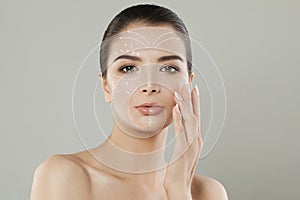 Pretty woman. Face lift anti-aging lines on young female face. Graphic lines showing facial lifting effect on skin.