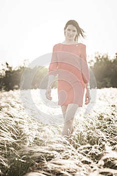 Pretty woman in feather-grass field