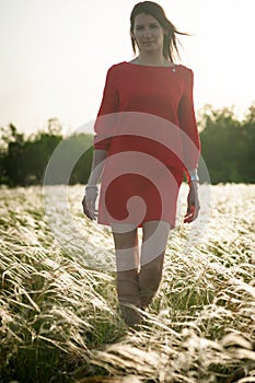 Pretty woman in feather-grass field