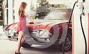 Pretty woman filling her car with petrol at gas station. Woman man refuelling a car at a petrol station.