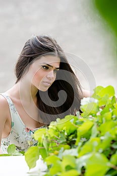 Pretty woman with flowered dress,greens on foreground
