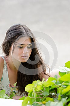 Pretty woman with flowered dress,greens on foreground