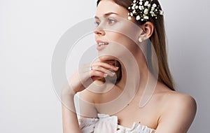 Pretty woman flowers In her hair attractive look charm white dress