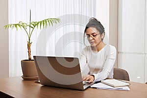 pretty woman in glasses using laptop at home