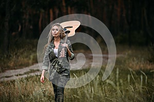 Pretty woman guitar nature fashion look concept.