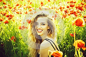 Pretty woman or happy girl in field of poppy seed