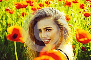 Pretty woman or happy girl in field of poppy seed