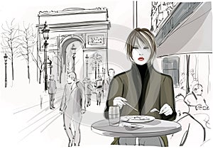 Pretty woman having a lunch at the Champs-Elysees in Paris