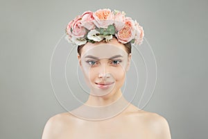 Pretty woman with healthy skin and rose flowers wreath portrait. Pretty candid girl with flowers. Facial treatment
