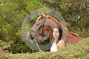 Pretty woman and her chestnut horse