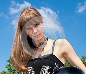 A pretty woman hold a black motorcycle helmet