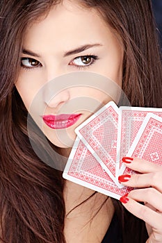 Pretty woman holding gambling cards