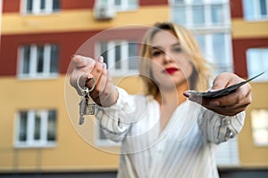 Pretty woman holding keys to new house