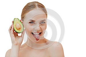 Pretty woman holds half an avocado in front of her face. Photo of attractive woman with perfect makeup on white background. Beauty