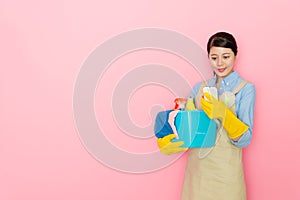 Pretty woman houseworker using mobile smartphone