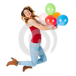 Pretty woman jumping with olorful balloons isolated on white background