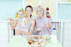 Pretty woman in the kitchen with the baby.