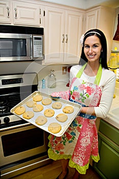 Pretty Woman in Kitchen Baking Cookies