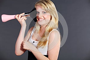 Pretty woman with large rouge brush
