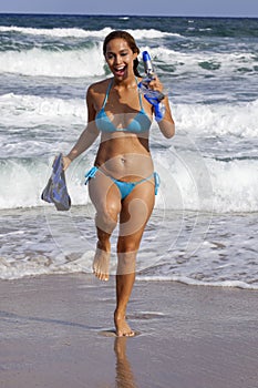 Pretty woman in light blue bikini going snorkeling