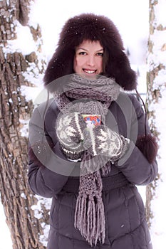 Mujer bonita mirar en el invierno taza de té 