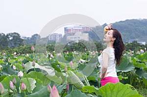 A pretty woman in lotu fields