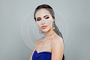 Pretty woman with makeup, jewelry diamond necklace and pearls earrings portrait