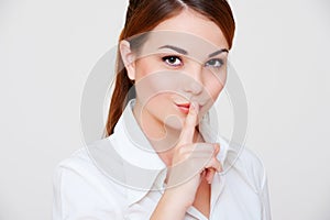 Pretty woman making silence sign