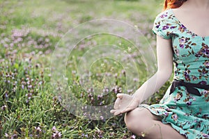 Pretty woman meditate in the park